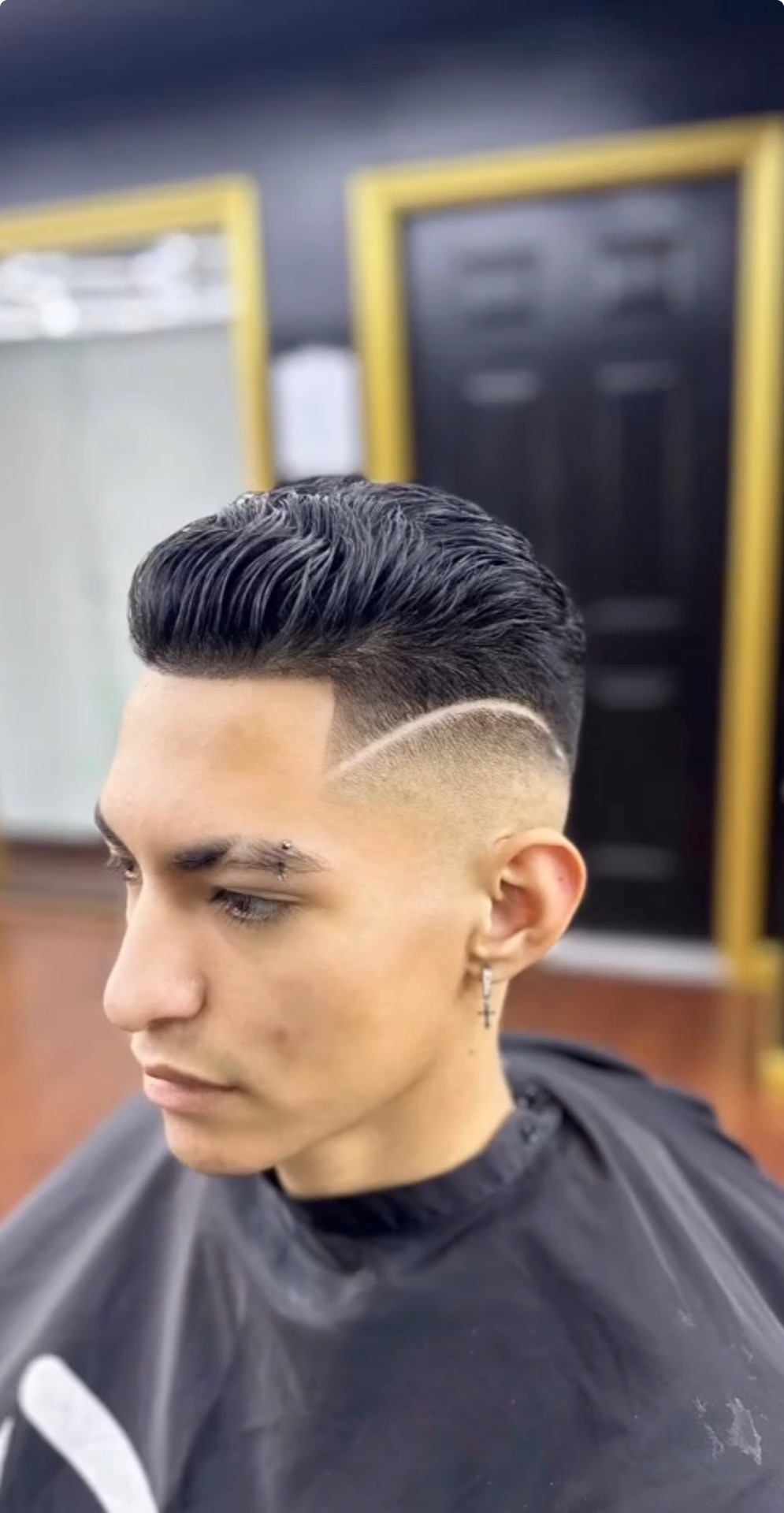 Curly top with sculpted full beard